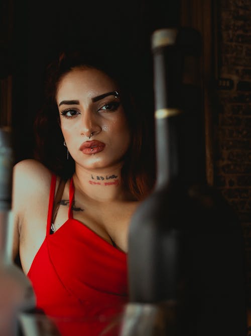 A Woman in Red Tank Top with Piercings on Her Face