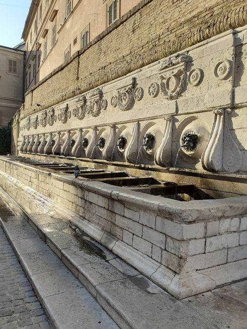Free Historic stone fountain with intricate bas reliefs in Ancona, Italy. Stock Photo