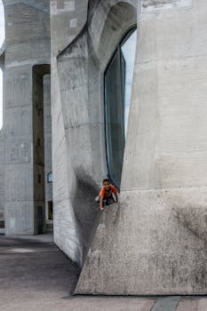 Child playing on unique concrete architecture in Dornach, Switzerland.