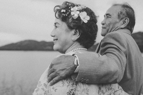 Free Elderly couple sharing a romantic moment by the serene lake, symbolizing enduring love. Stock Photo