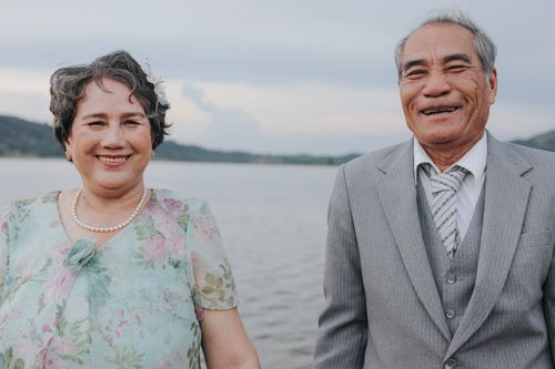 Free Happy elderly couple enjoying a day by the sea, smiling warmly. Stock Photo