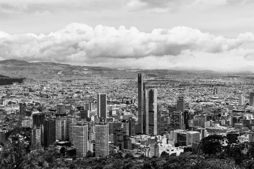 Grayscale Photography of City Buildings Under Cloudy Sky