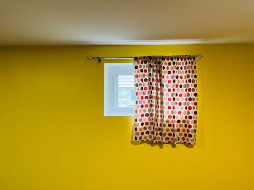 A Polka Dots Curtain and Yellow Wall