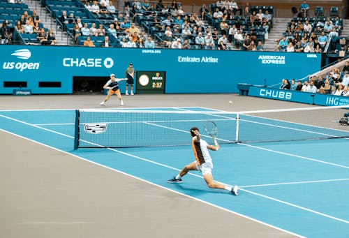 Two Men Playing Tennis Together 