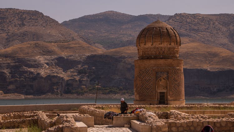 Ancient Temple Near Water And Hills