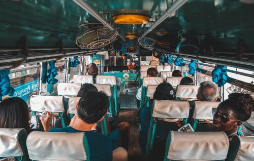 Free A diverse group of tourists traveling on a bus in Kanchanaburi, Thailand. Stock Photo