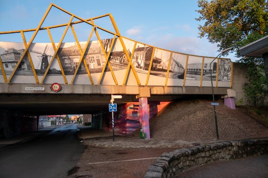 Artistic bridge with a mural depicting historical scenes in Maarheeze, Netherlands.