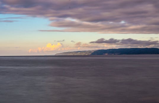 Dramatic seascape with clouds over an expansive ocean. Perfect for nature and travel themes.