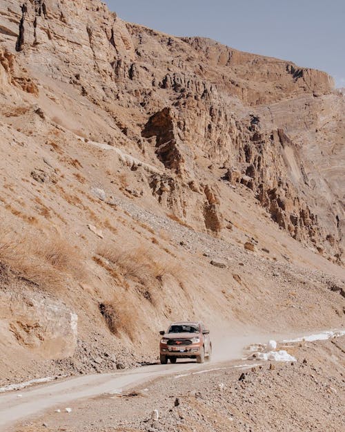 A Car on the Road Near the Rocky Mountain