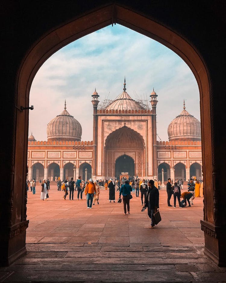 Pink Toned Photo Of Oriental Architecture And People On A Square