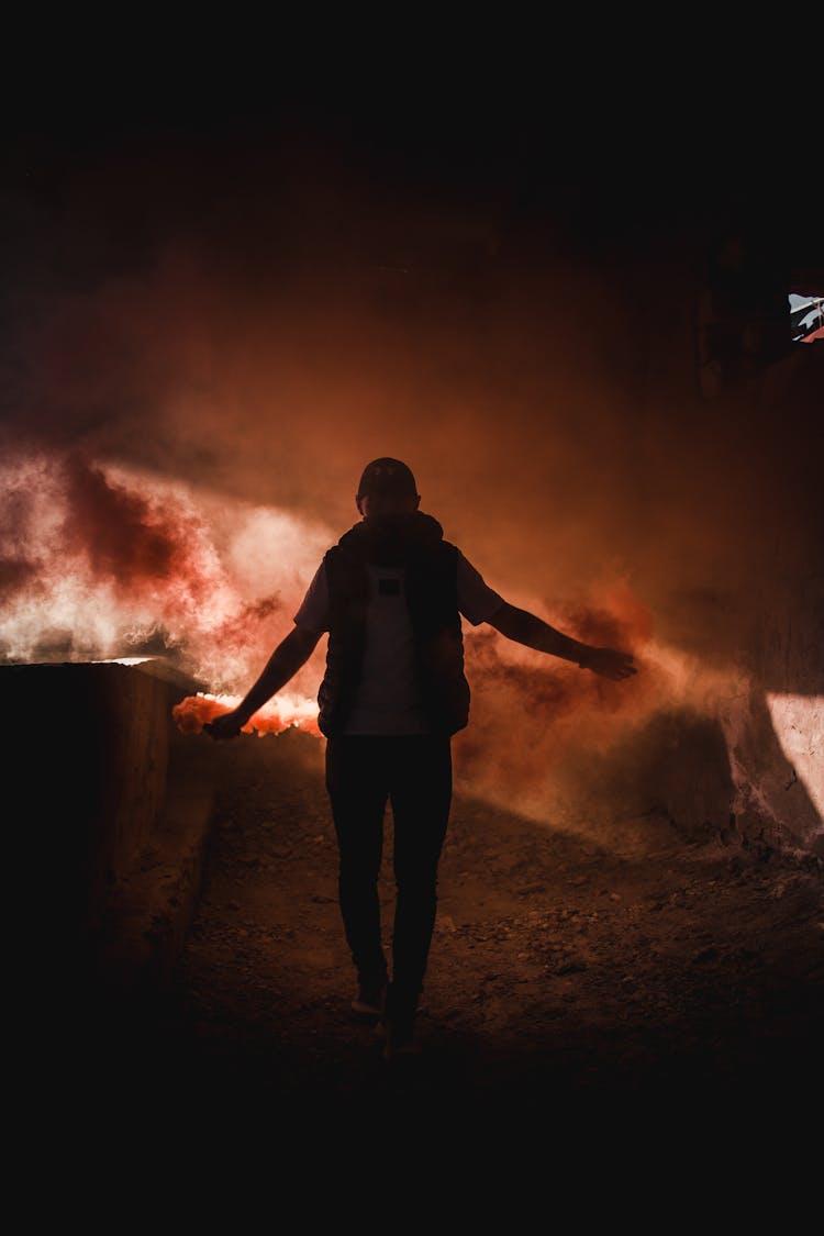 Man Walking With Red Flares