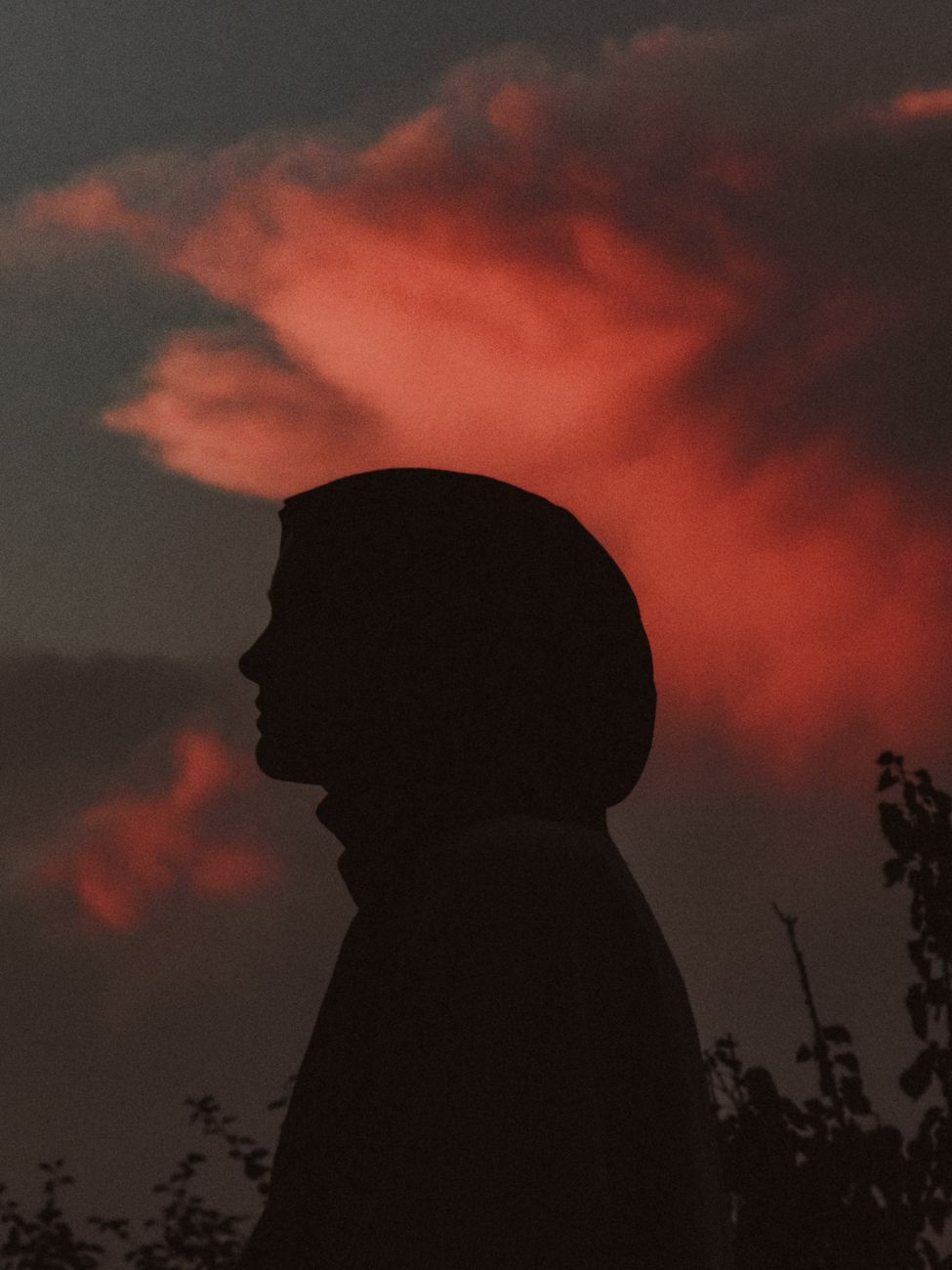 A tranquil silhouette of a woman against a vibrant twilight sky, evoking serenity.. tranquil, silhouette, woman