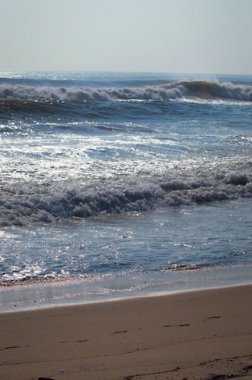 Free Waves crashing on the sunny shores of a beach in Chennai, India. Stock Photo