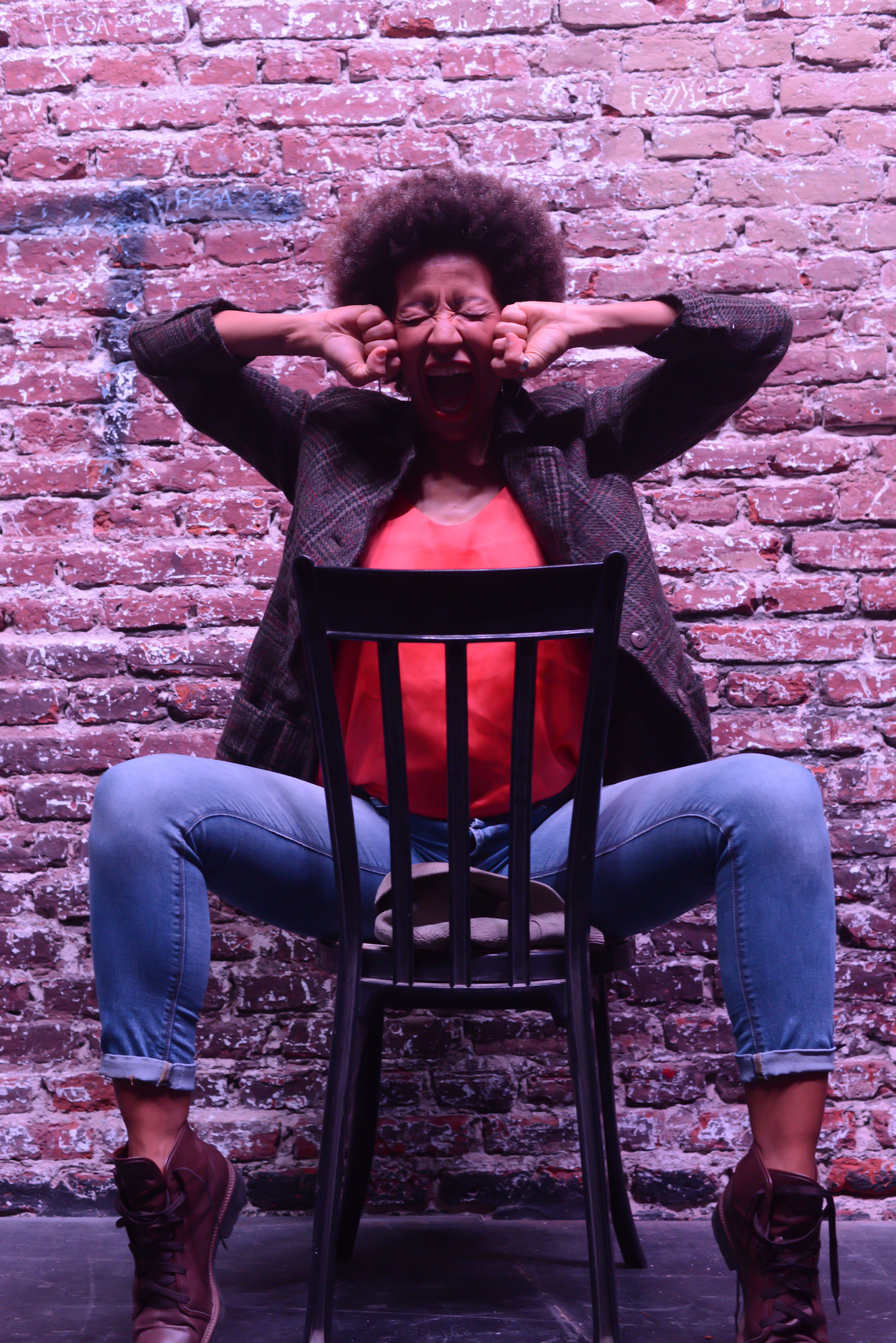 A Woman in Plaid Blazer and Denim Jeans Sitting on the Chair · Free ...