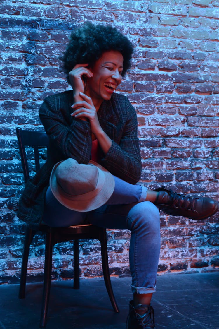 Laughing Woman Sitting On A Chair