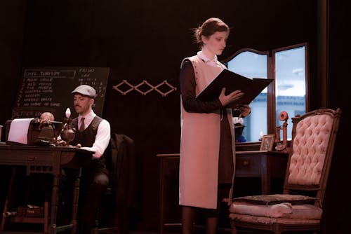 Woman in Black and White Dress Reading a Book