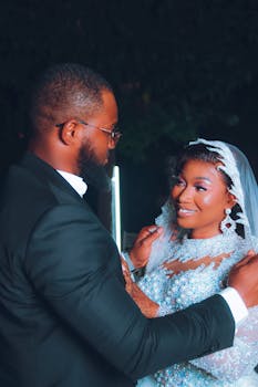 A beautiful moment of newlyweds embracing with joy and love at their wedding ceremony.