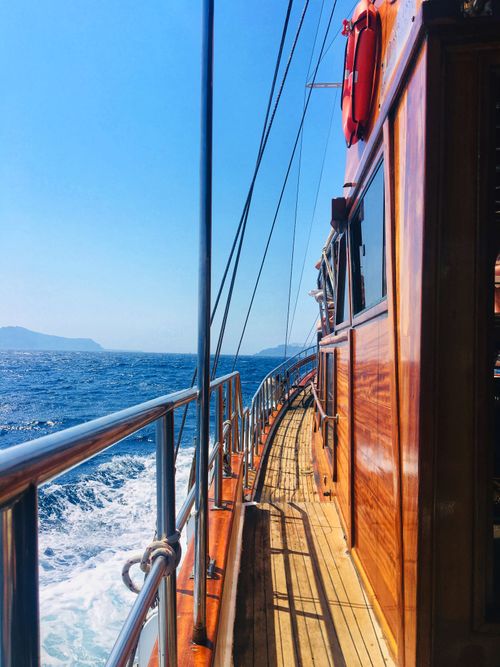 Free Experience the serene beauty of a sailing trip near Thera, Greece on a classic wooden vessel. Stock Photo