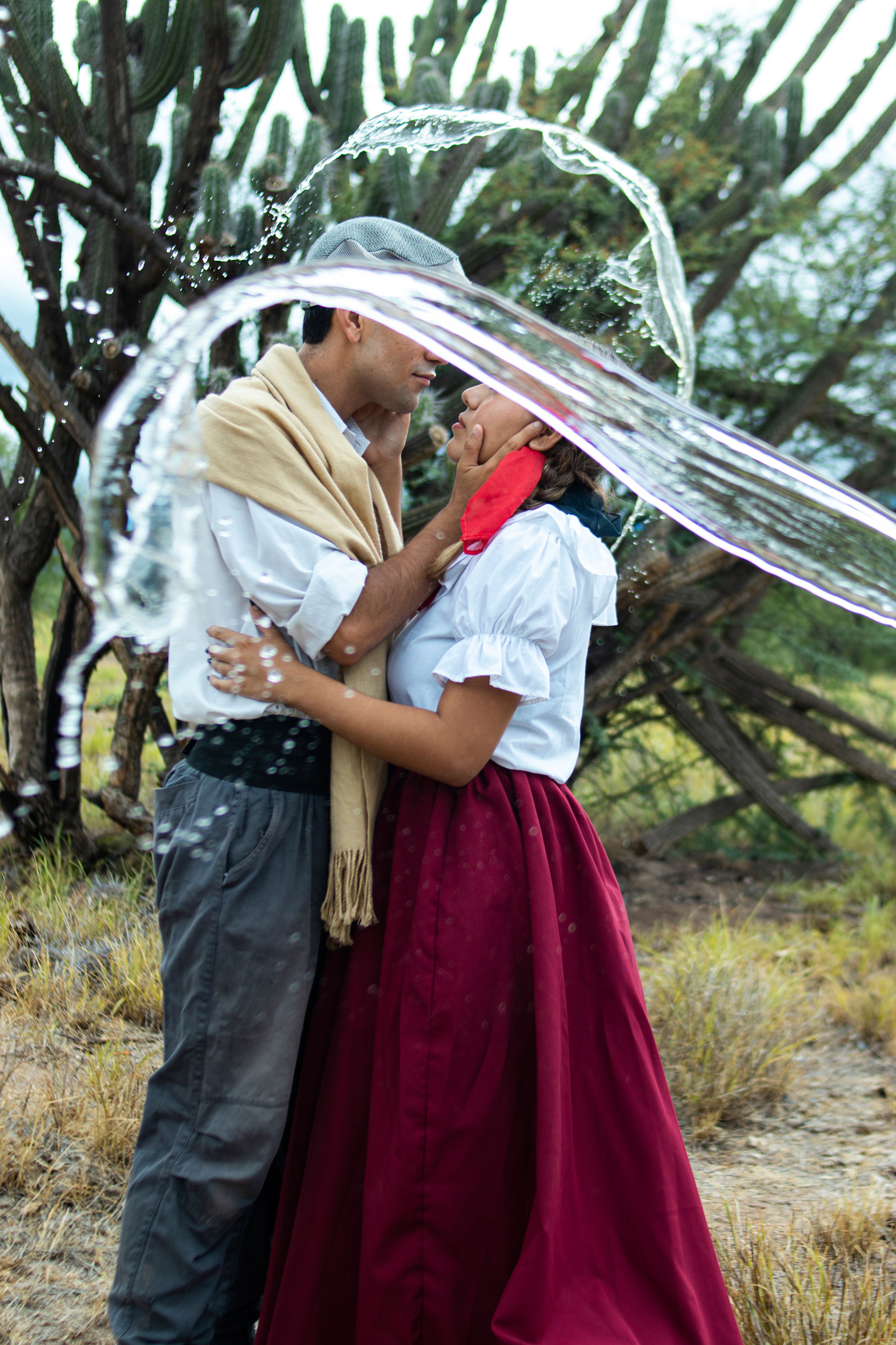 Young Couple in Traditional Clothing Dancing Together · Free Stock Photo