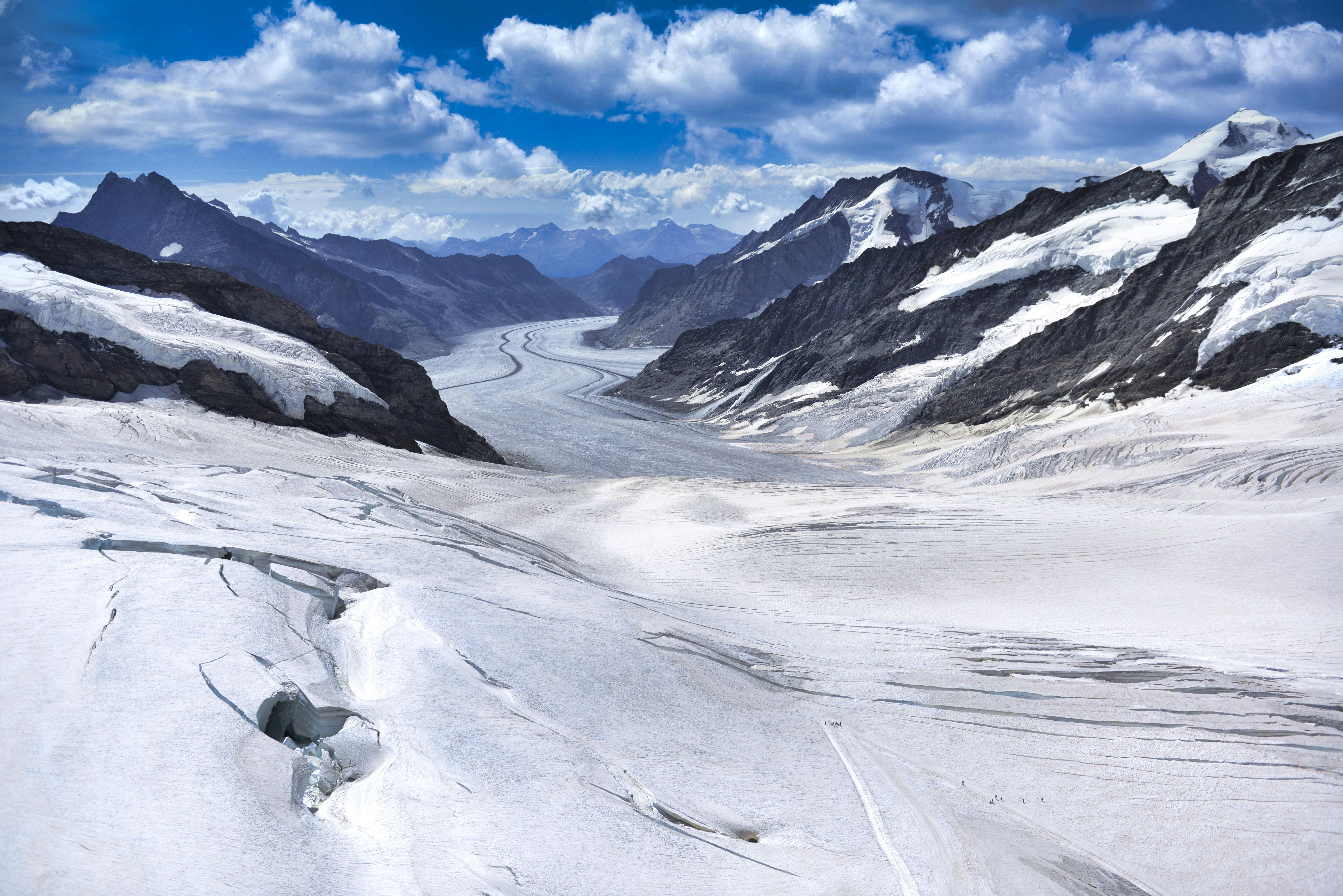 A stunning panoramic view of the snow-covered Jungfrau Glacier in Grindelwald, Switzerland.
