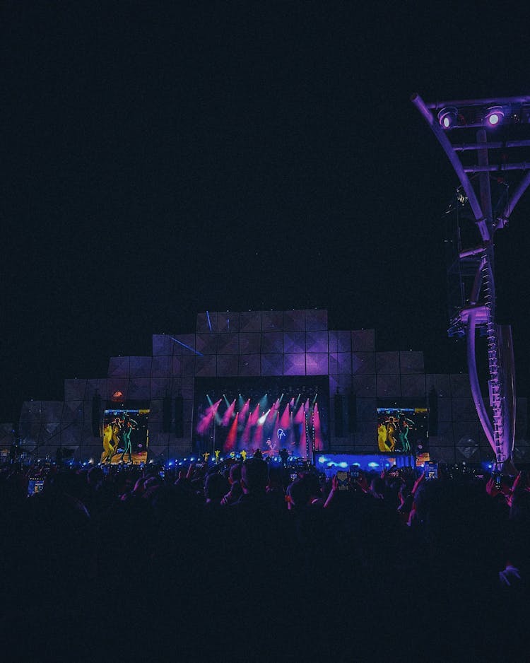 People Watching An Outdoor Concert During Night Time