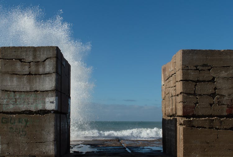 Waves Crashing On Concrete Structure 