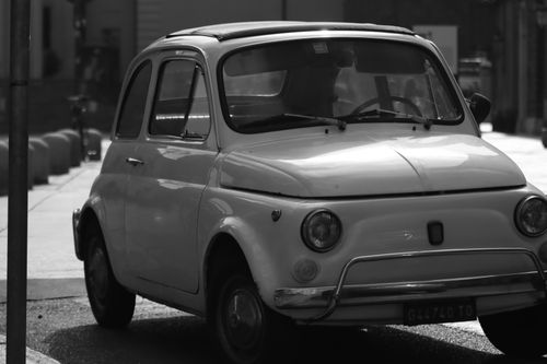 Free Monochrome photo of a parked vintage Fiat 500 in Turin, Italy, showcasing classic Italian automotive design. Stock Photo