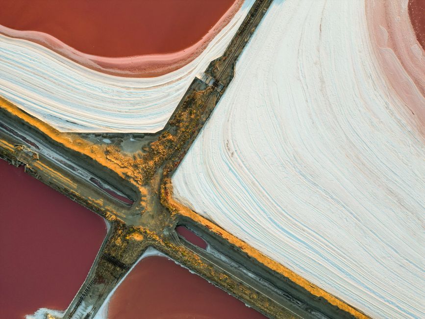 Stunning aerial shot of colorful salt ponds with unique textures and patterns.