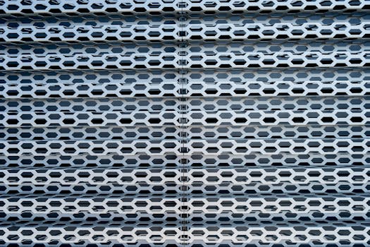 Close-up view of an industrial metal mesh pattern with hexagonal shapes and texture.