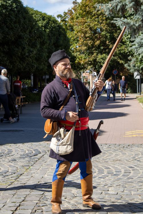 Free Man dressed as vintage soldier with rifle and sword, Szigetvár street performance. Stock Photo