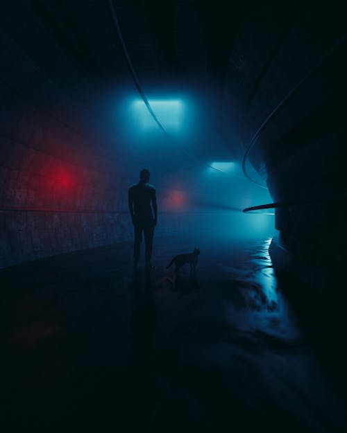 Man in Black Jacket Standing on Tunnel