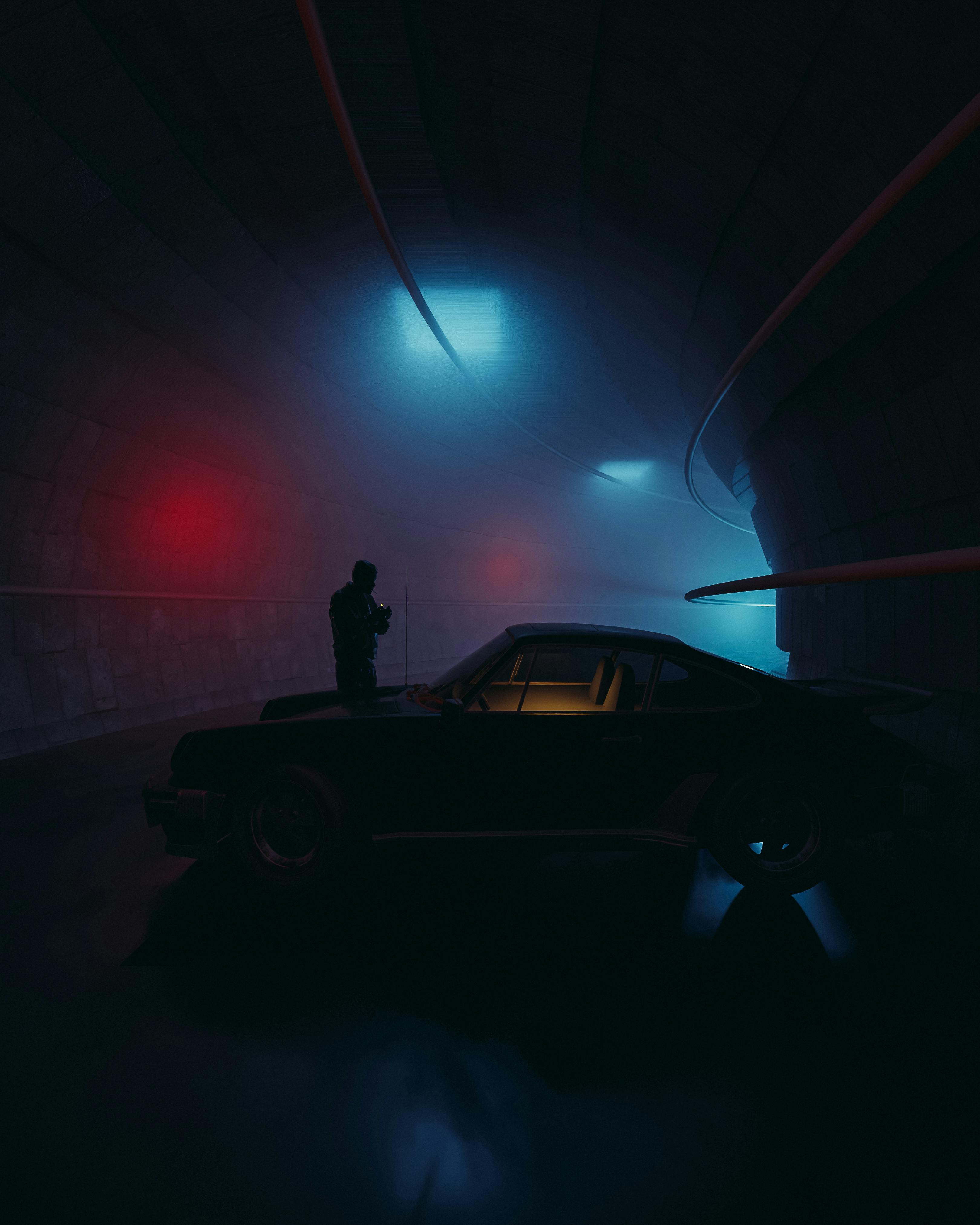 man in black jacket standing beside black car