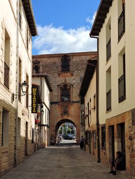 Explore the historic charm of Covarrubias, Spain captured through a scenic alley view.