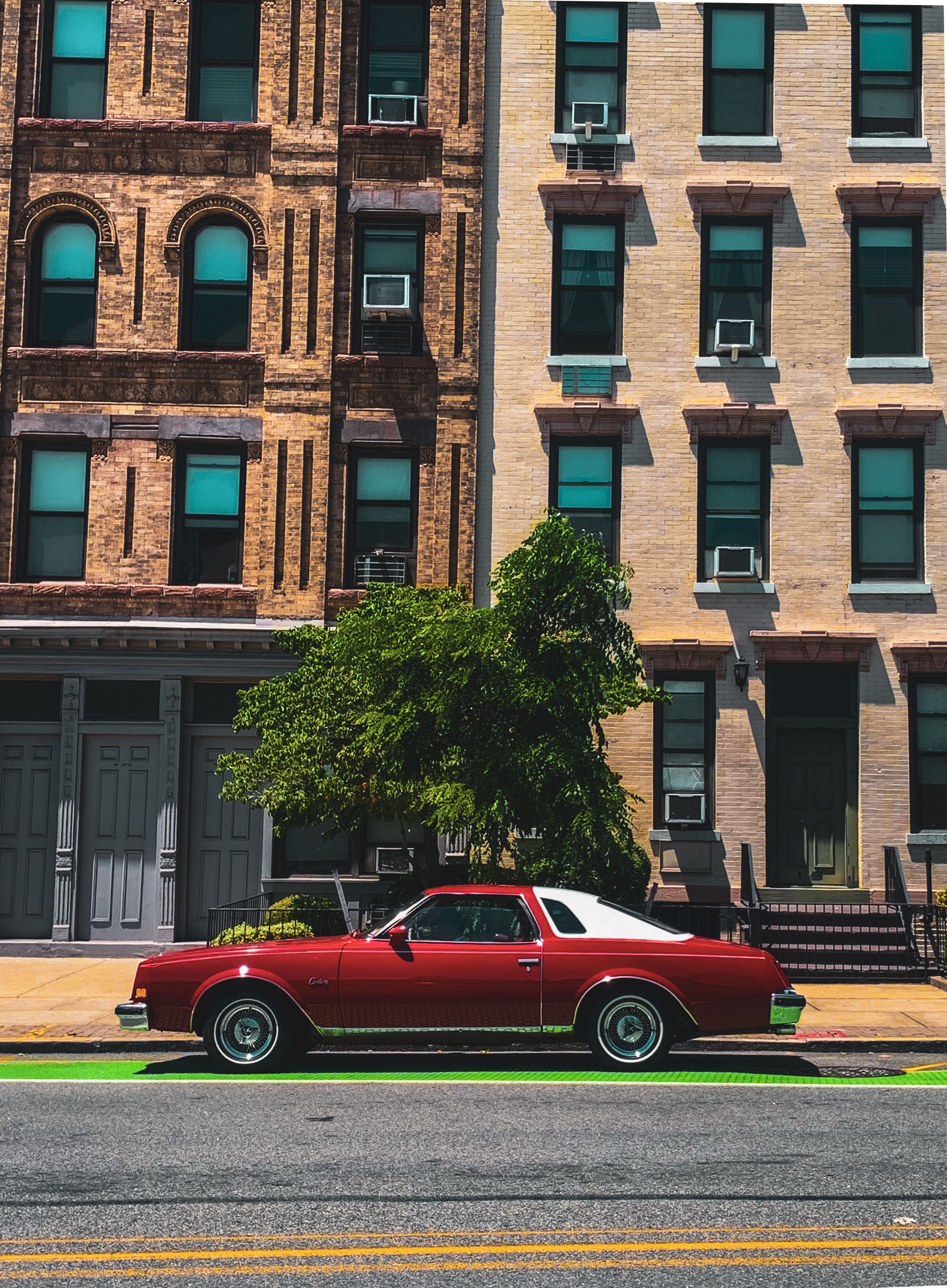 Red Classic Car Parked in Front of a Building · Free Stock Photo
