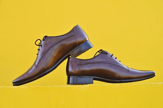 Stylish brown leather shoes displayed against a bright yellow background. Perfect for fashion and lifestyle themes.