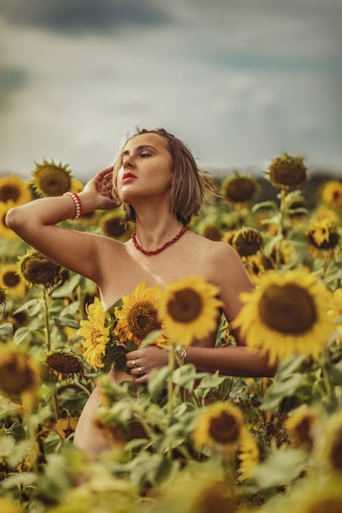 A Woman Standing Naked in a Field