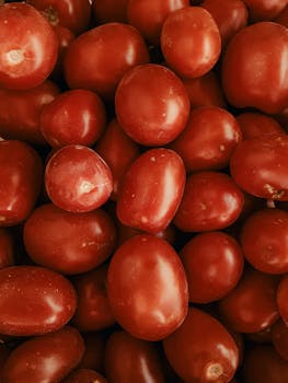 Vibrant red grape tomatoes close-up, highlighting freshness and abundance for food-oriented visuals.