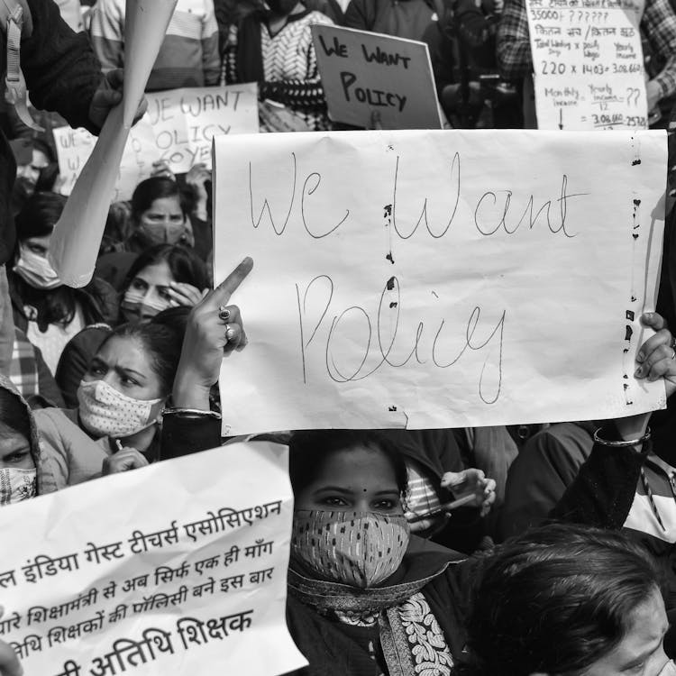 Grayscale Photo of People Holding Placards