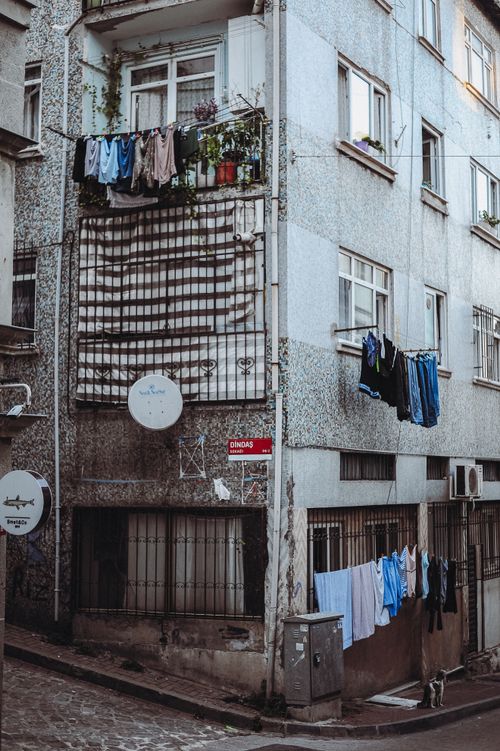 Free Laundry hanging on an apartment building facade, urban scene. Stock Photo