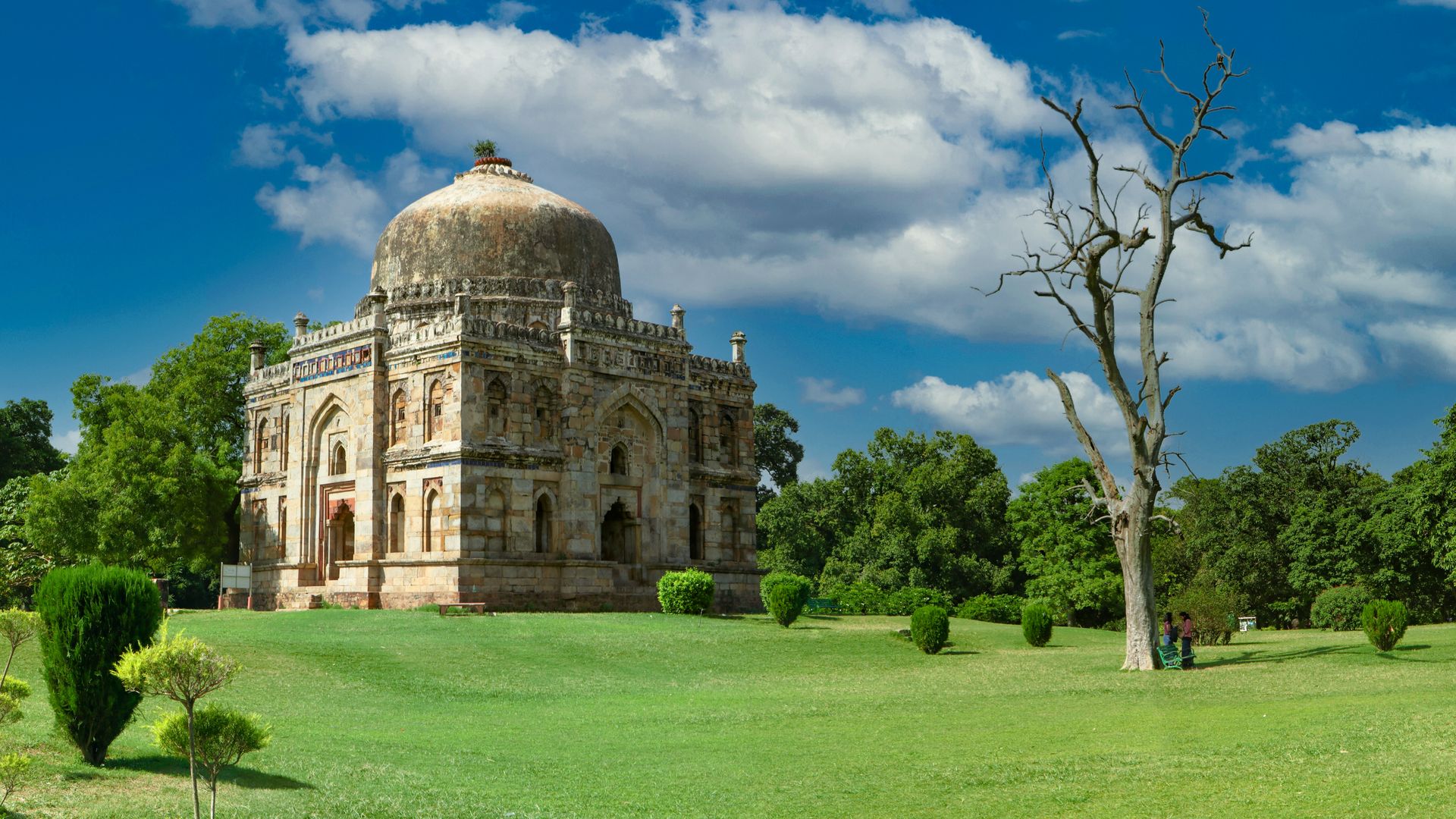 Explore the historic Mughal architecture in Lodhi Garden, New Delhi, surrounded by lush greenery.
