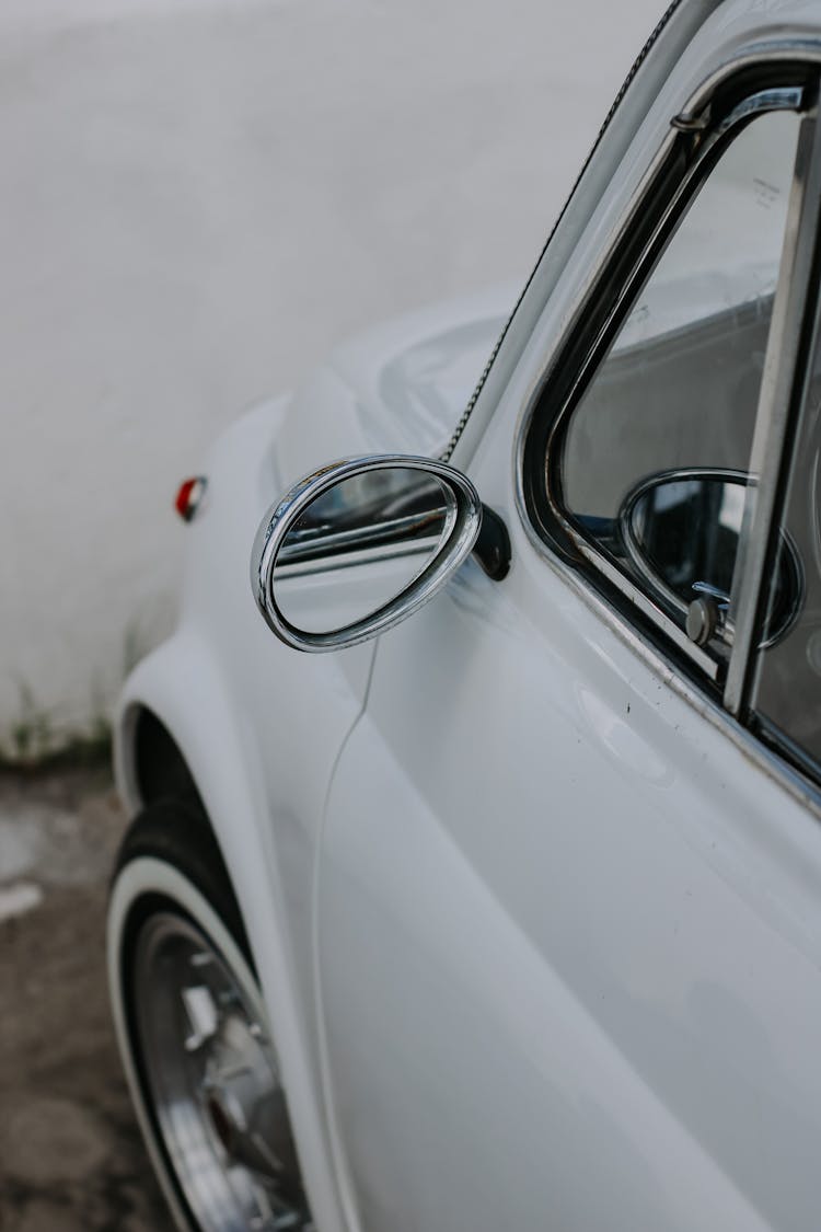 Close-up Of Rear View Mirror Of A White Car 