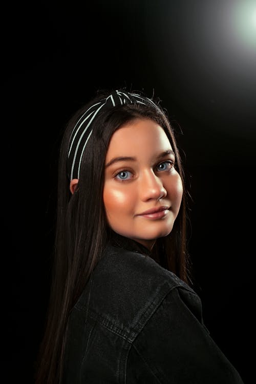 Close-Up Shot of a Beautiful Girl on Black Background