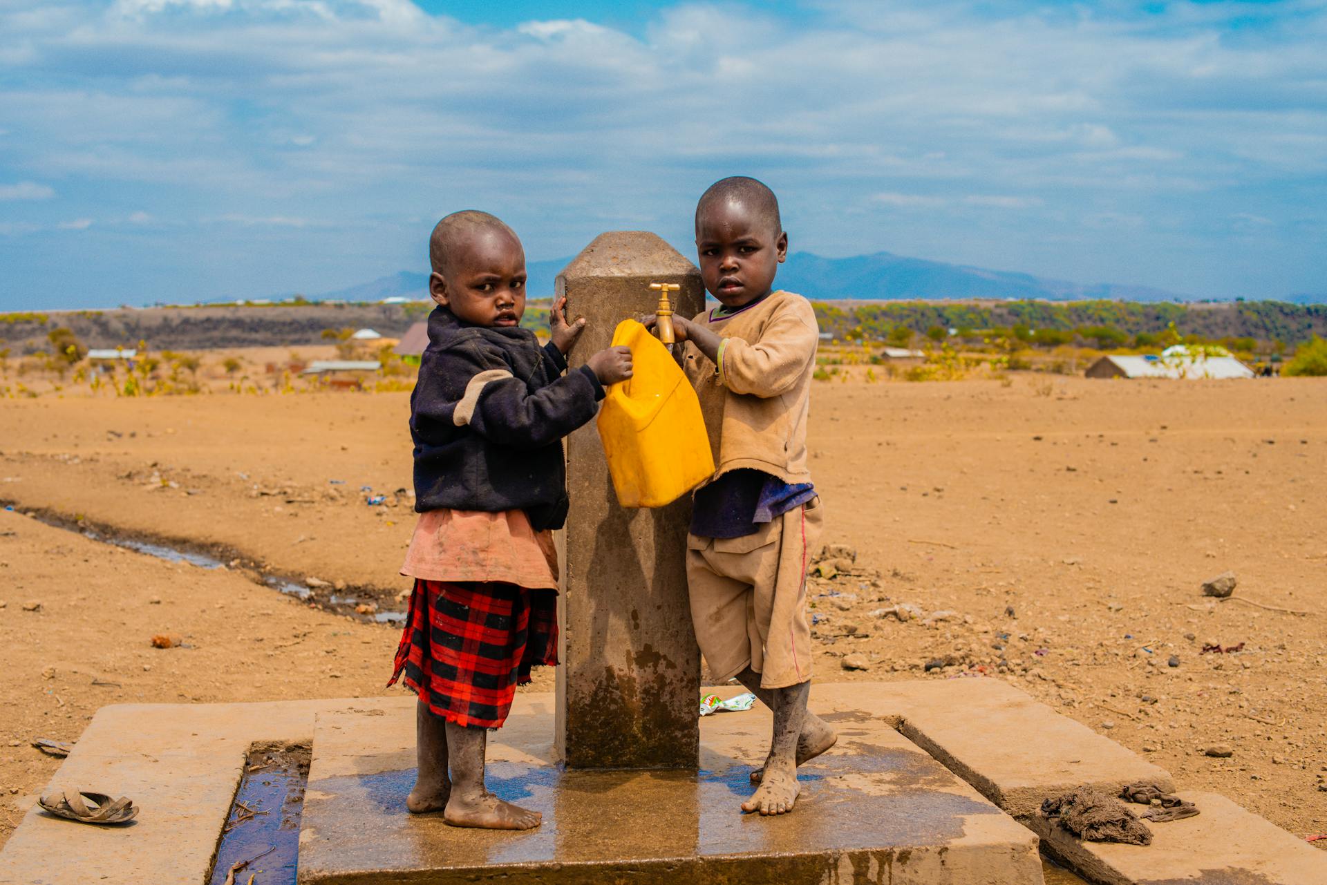 Children Taking Water from Public Tap