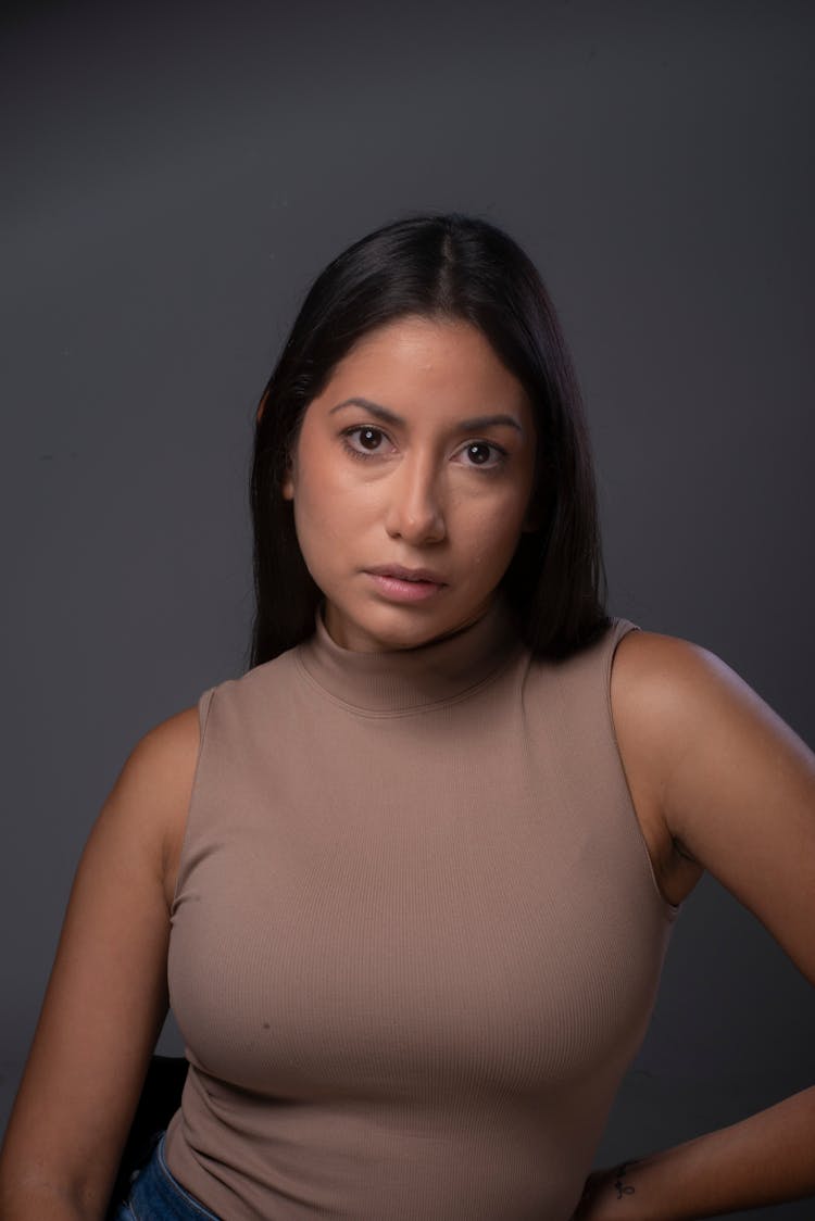 A Woman In Brown Sleeveless Shirt