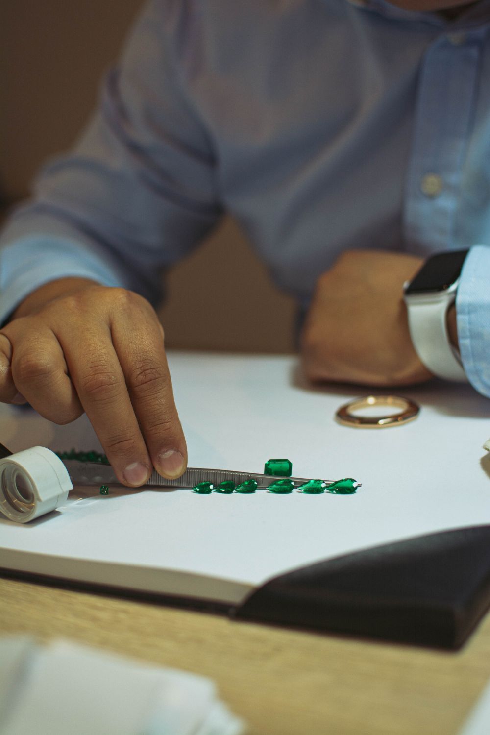 A dealer examining rough stones by hand
