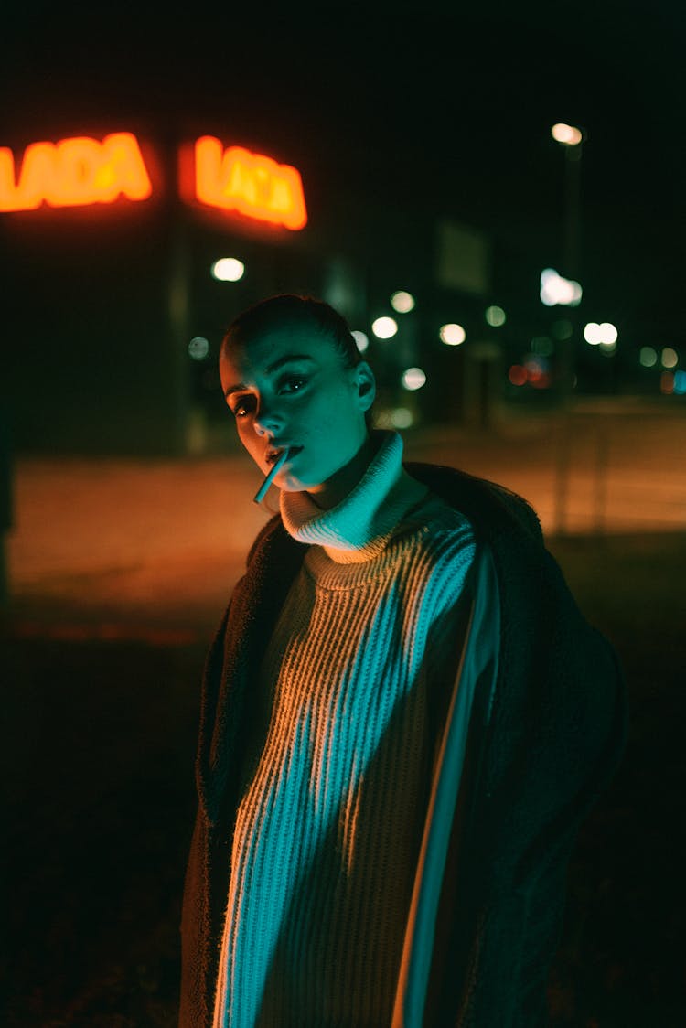 Woman In Sweater Dress And Coat At Night