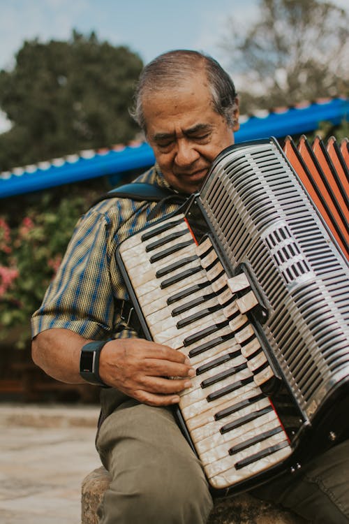 An Elderly Man Playing a Vintage Accordion