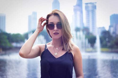 Beautiful Woman in Blue Tank Top Wearing Sunglasses