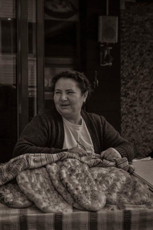 A Woman Selling Food at a Market Stall