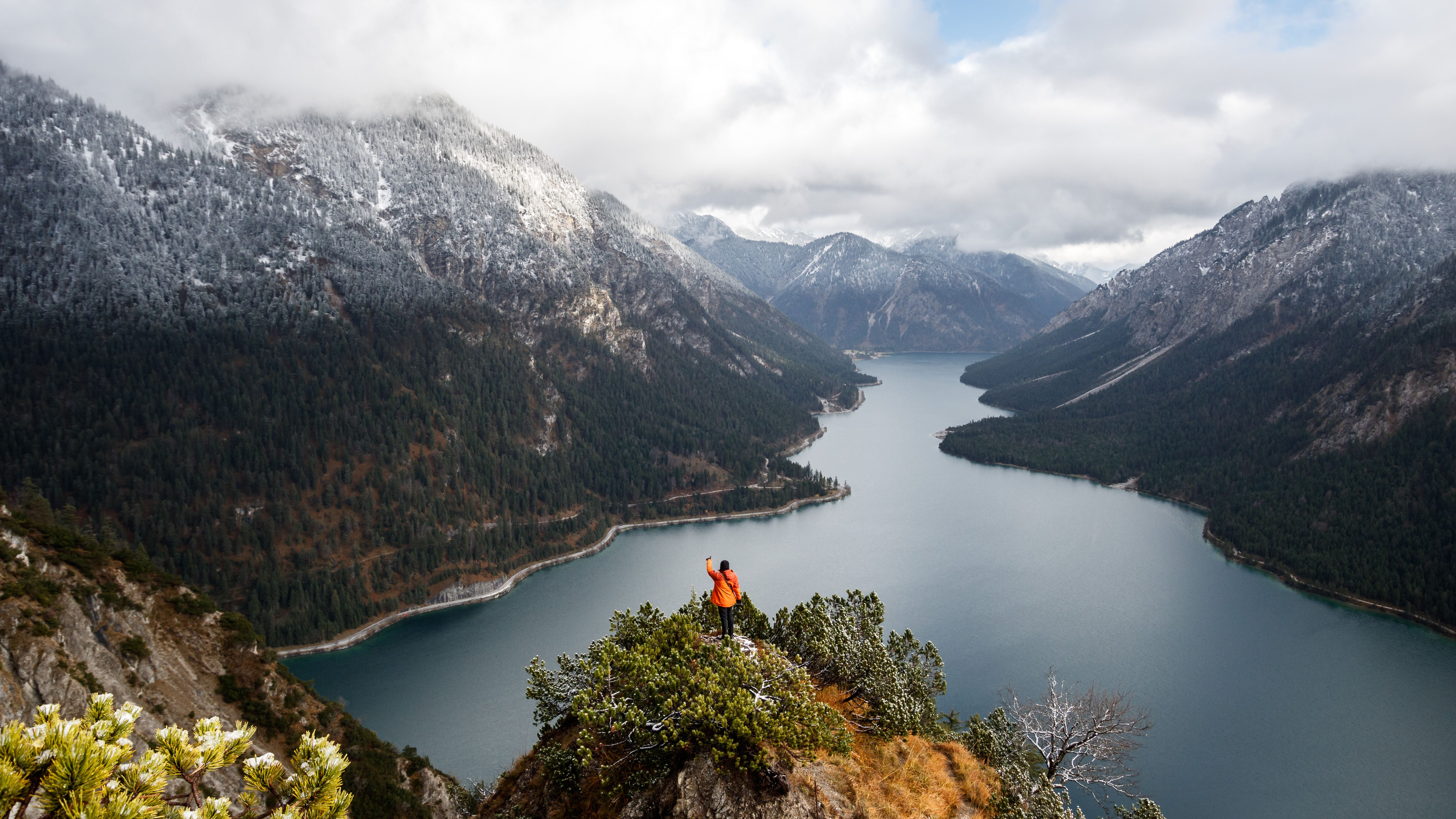 A Person in Black Shirt Sitting on the Big Rock · Free Stock Photo